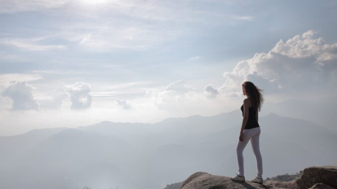 woman-standing-on-a-rock-looking-at-nature-s-view-3866766