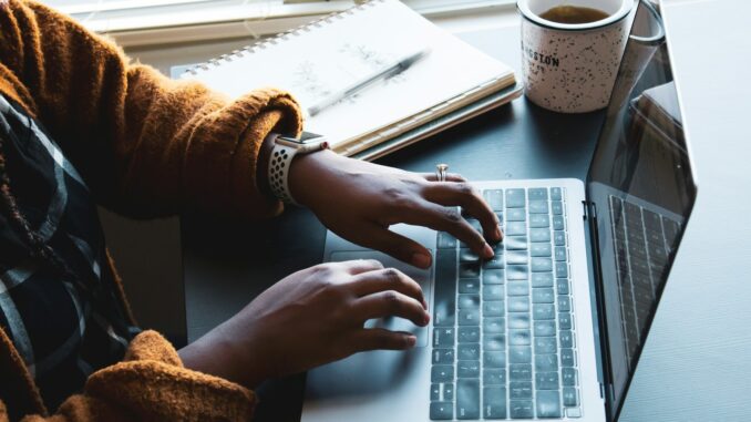 person using black and silver laptop computer