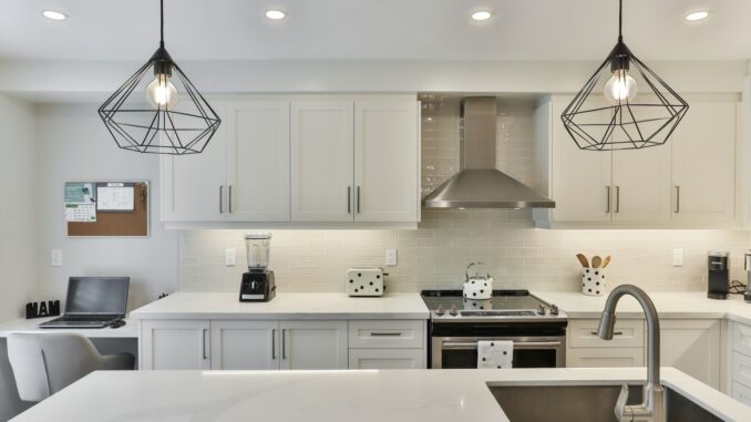 white wooden kitchen cabinet with black pendant lamp