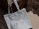 a white bag sitting on top of a chair