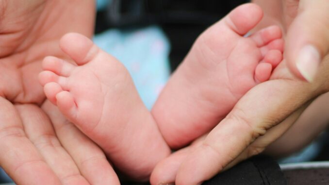 Photo by Bonnie Kittle person holding baby feet