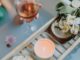 A serene bath setting with wine, candles, and flowers for a relaxing spa experience.